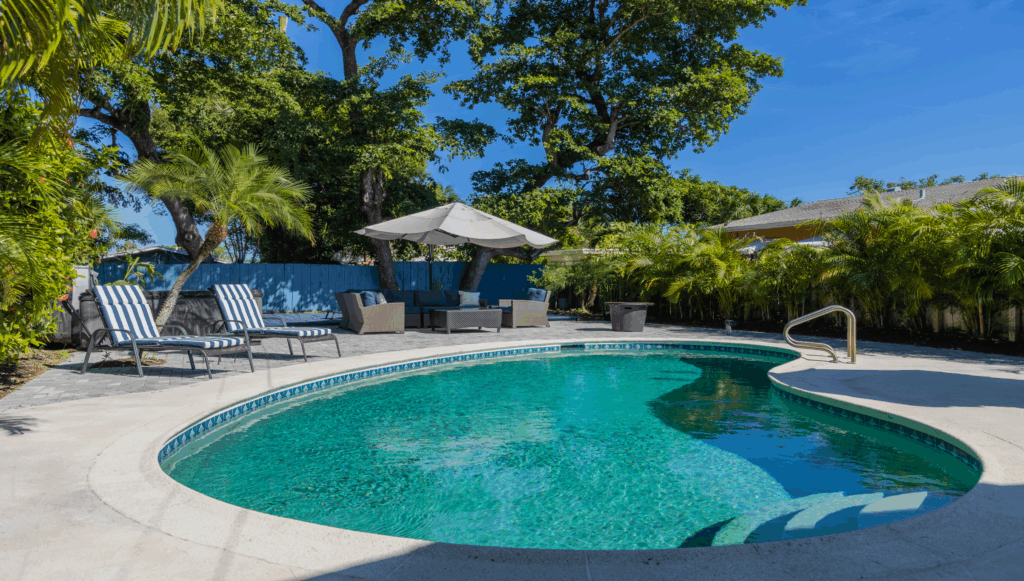 backyard-modern-house-with-swimming-pool-artificial-grass-stone-path-trees-chairs-fotor-202511050340